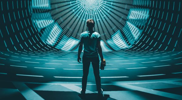 Man standing in front of symmetrical light projection A man standing in front of symmetrical light projection