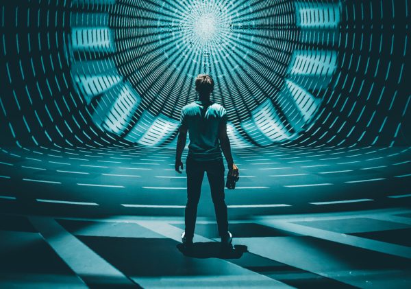 A man standing in front of symmetrical light projection